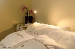 a bed with white pillows with a note on it at Zimmer you dreamed of in Arad