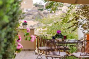 a table and chairs on a patio with flowers at Zimmer you dreamed of in Arad