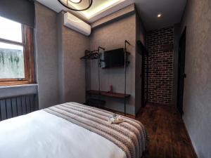 a bedroom with a bed and a tv on the wall at GalataCo Hotel in Istanbul