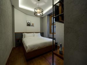 a bedroom with a bed and a lamp at GalataCo Hotel in Istanbul