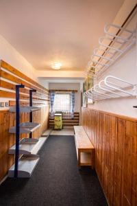 a room with wooden walls and a staircase and a bench at Apartmán Braun in Rokytnice nad Jizerou