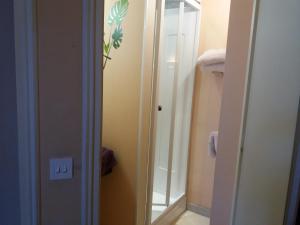 a bathroom with a mirror next to a door at Hôtel Le Centre in Les Herbiers