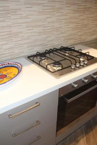 a kitchen with a stove and a plate on a counter at Mamiani Suite in Castellammare del Golfo