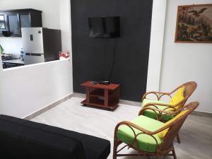 a living room with a couch and chairs and a table at Twin Villa 22 in Katugastota
