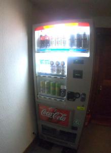 a cocacola soda vending machine with drinks in it at Monkey Rider in Hakuba