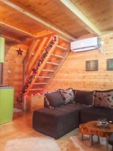 a living room with a couch and a stairs at Brvnara Borovik in Cetinje
