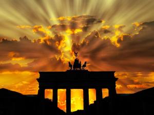 a silhouette of the acropolis with a sunset in the background at City-Apartment Zille in Berlin