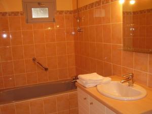 a bathroom with a sink and a bath tub at Logis Hôtel Restaurant Chez Nous in Sainte-Croix +24 photos