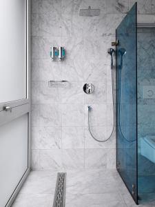 a shower with a glass door in a bathroom at Amadi Park Hotel in Amsterdam