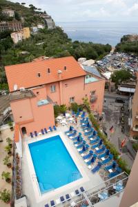 an aerial view of a resort with a swimming pool and chairs at Hotel Villa Maria in Sorrento