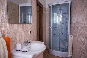a bathroom with a sink and a shower at Appartamenti La Casina in Porto Azzurro +88 photos