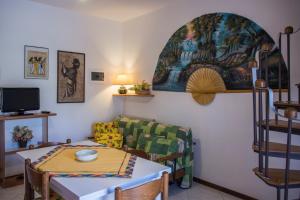 a living room with a table and a couch at Appartamenti La Casina in Porto Azzurro
