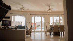 a living room with a dining table and chairs at Jacaranda in Sharm El Sheikh