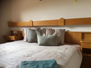 a bedroom with a large bed with white sheets and pillows at Ferienwohnung Lassendorf in Hermagor