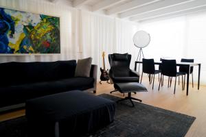 a living room with a couch and a table and chairs at Le Cupole Suites & Apartments in Trapani