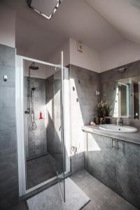 a bathroom with a shower and a sink at SUNLIGHT GOLD Penthouse Szeged - Exclusive in Szeged
