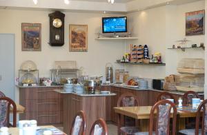 a restaurant with a counter and a tv on the wall at Hotel Rössli in Interlaken