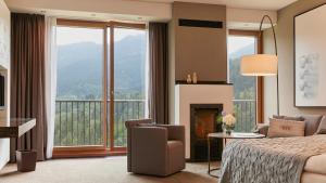 a hotel room with a bed and a fireplace at Kempinski Hotel Berchtesgaden in Berchtesgaden