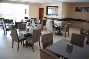 a dining room with tables and chairs in a restaurant at ALENCAR HOTEL in Barreiras