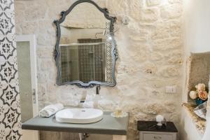 bagno con lavandino e specchio di Casa di Amici a Ostuni