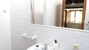 a bathroom with a sink and a mirror at La Carriella in Colombres +18 photos