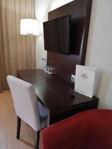 a wooden table with a lamp on top of it at Hotel Monaco in Faro