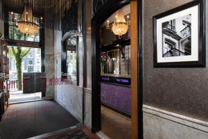 a hallway of a restaurant with a picture on the wall at The Pavilions Amsterdam, The Toren in Amsterdam