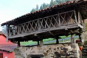 a wooden bridge on top of a stone wall at Casa Rural Ofelia in Cudillero