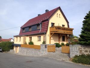 a large yellow house with a red roof at FeWo „Zum Napoleonstein“ in Dresden