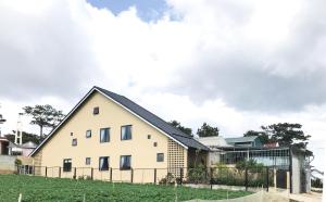 a white house with a black roof at DaLaHa City in Da Lat
