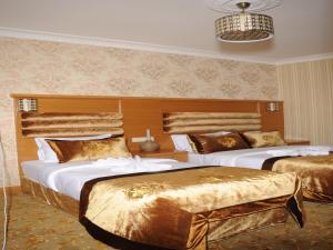 A bed or beds in a room at Alfa Hotel