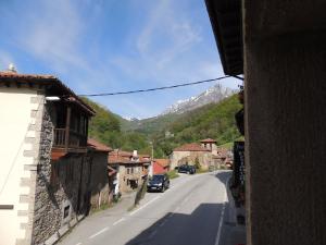 a street in a village with a mountain at Posada Maximo in Espinama