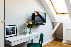 Televízia a/alebo spoločenská miestnosť v ubytovaní Apartamenty Koci Ogon