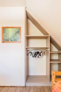 a built in closet under the eaves of a room at Ferienhaus Seegras in Trassenheide