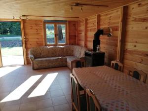 a living room with a couch and a table at Domki Kosewo in Mrągowo