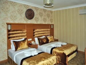 A bed or beds in a room at Alfa Hotel