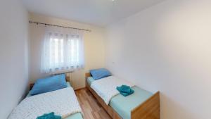 a bedroom with two beds and a window at Apartments Goga in Umag +65 photos