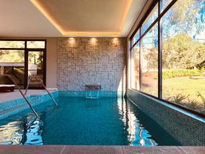 a swimming pool in the middle of a house at Paradiso Hotel & Spa in Merlo