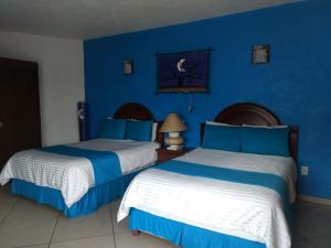 Postel nebo postele na pokoji v ubytování HOTEL JD TEPOZTLÁN