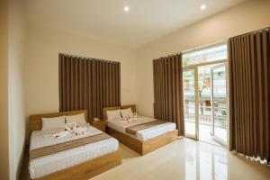 Ліжко або ліжка в номері Tuyet Suong Villa Hotel