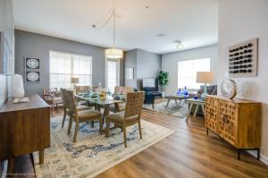 a dining room and living room with a table and chairs at Vista Cay Resort by Casiola in Orlando