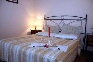 a bedroom with a bed with a candle on it at Agriturismo Le Docce in Castelfiorentino