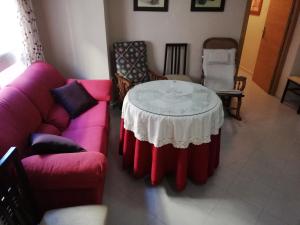 a living room with a table and two chairs at Apartamento centro in Antequera