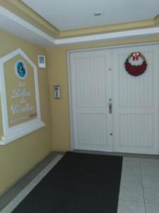 a garage with two white doors and a sign on the wall at Apartamento Centro Gramado in Gramado
