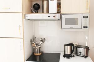 a kitchen with a microwave and a counter with utensils at Haus Sonnenhang in Lam +35 photos