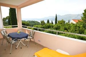 a table and chairs on a balcony with a view at Apartments Villa Ana in Cavtat