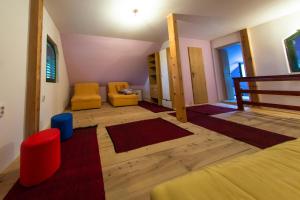 a room with two yellow chairs and a bed at Vikendica MM in Zlatibor