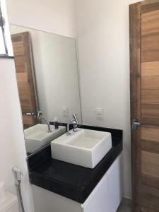 a bathroom with two sinks and a mirror at Gostoso White in São Miguel do Gostoso