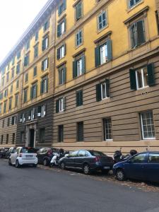 a large building with cars parked in front of it at Marvellous apt near Vatican in Rome