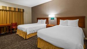 a hotel room with two beds and a desk at Best Western Stagecoach Inn in Pollock Pines